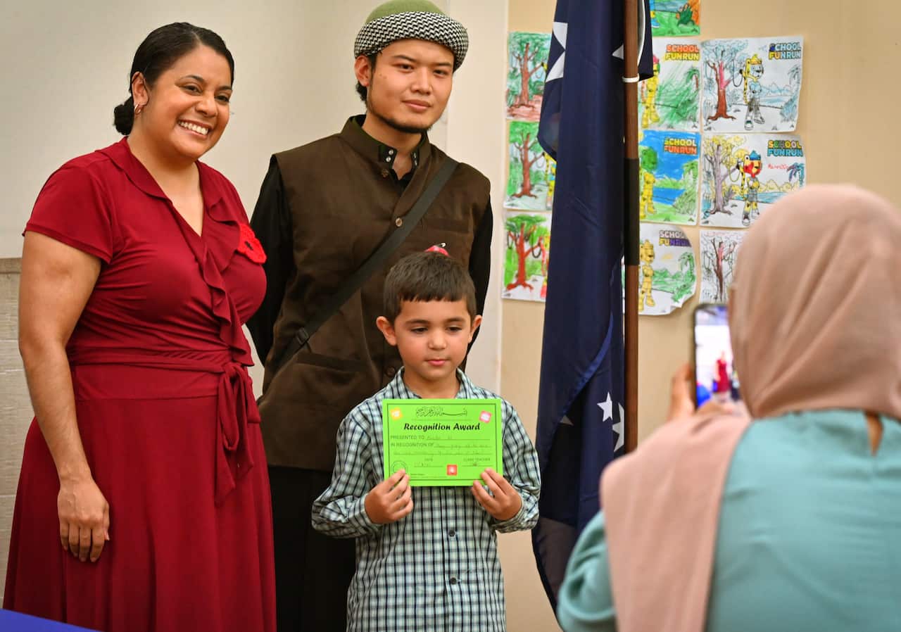 The NT Minister for International Education Ngaree Ah Kit helps to hand out merit awards to primary school students at the Australian International Islamic College in Darwin