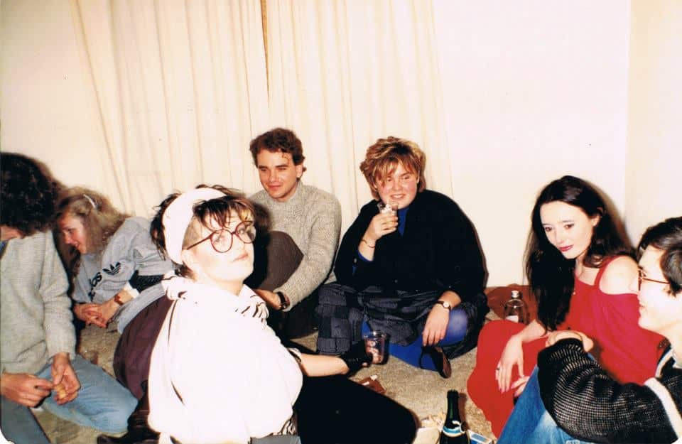 Colette and her friends sitting on the floor. 