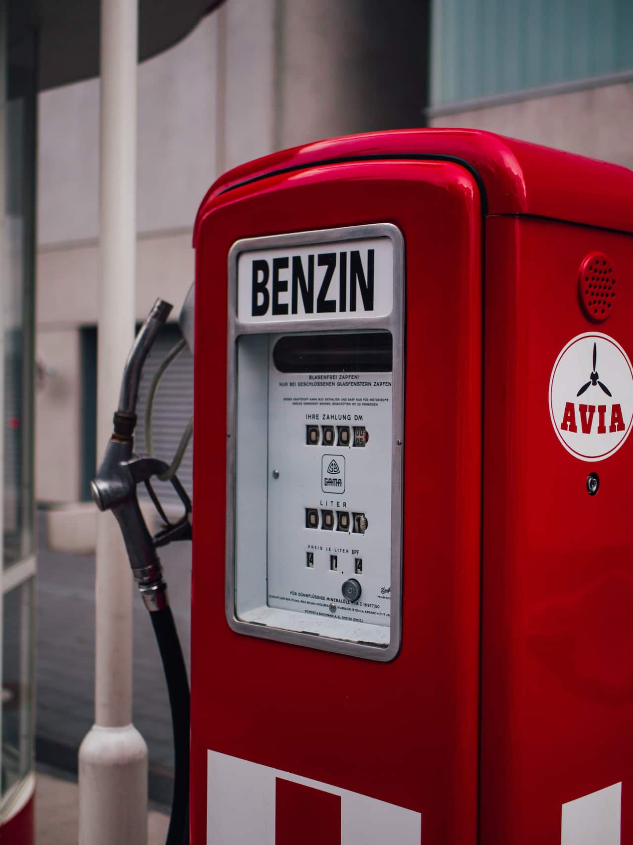 A bright red petrol pump labelled with the word Benzin.