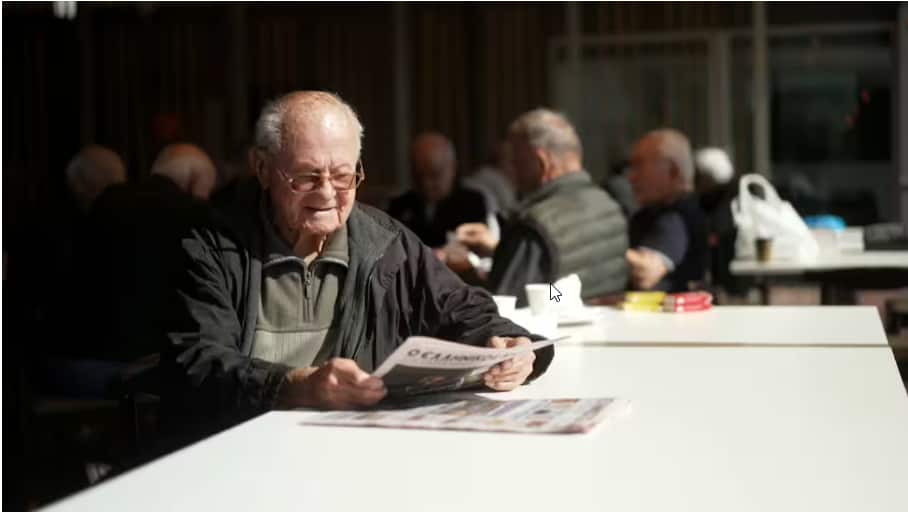 Pantelis Christou religiously reads the sports section of the Greek Herald..png