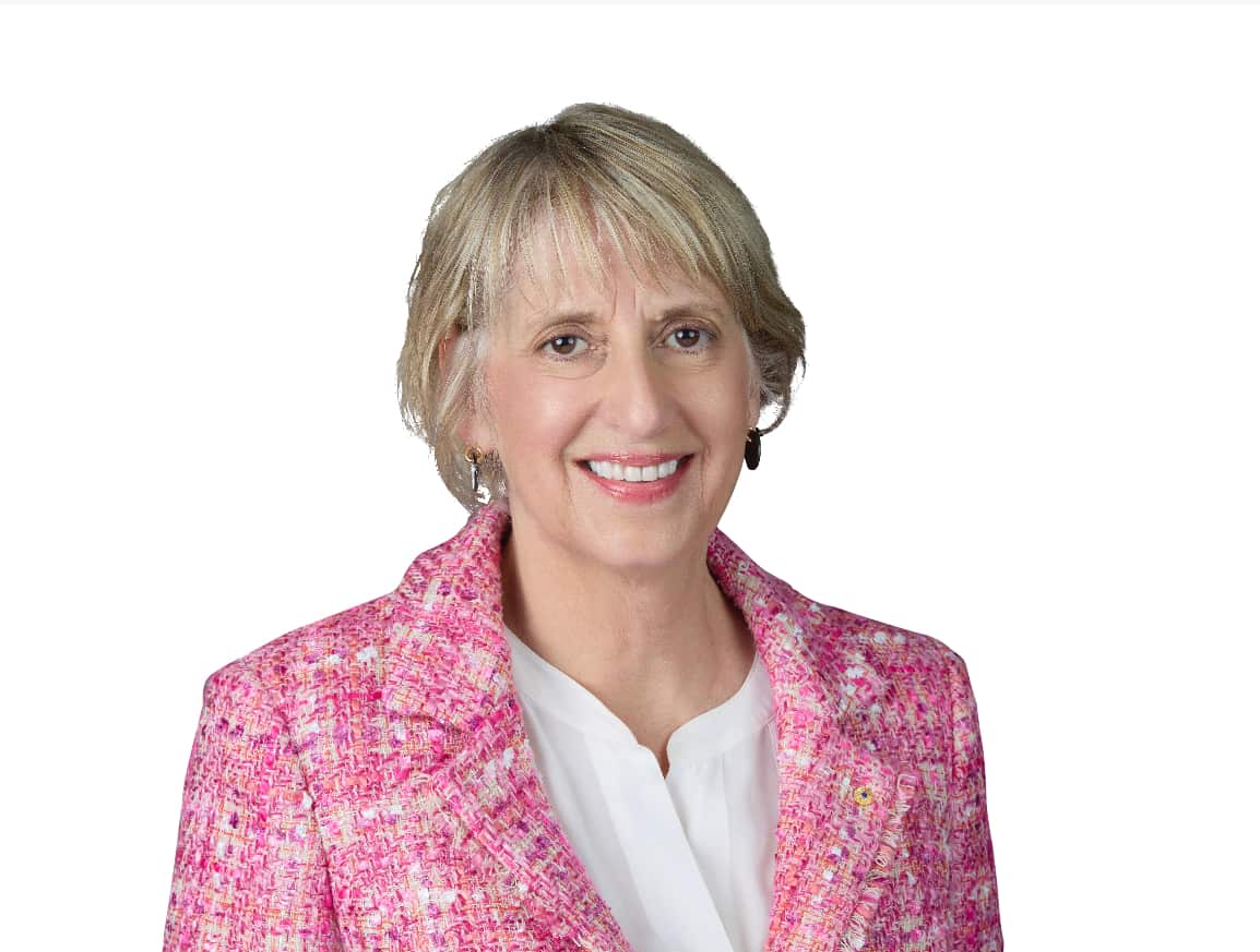 A woman in a pink jacket. 