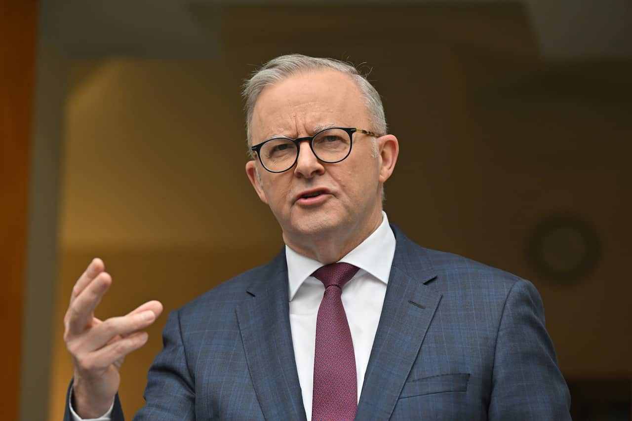 Prime Minister Anthony Albanese, wearing a suit, tie and glasses, is speaking.