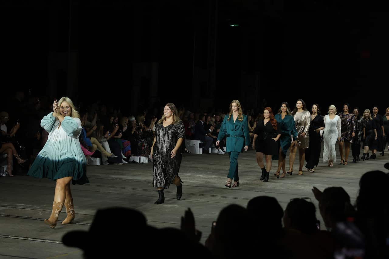Models walk down a runway