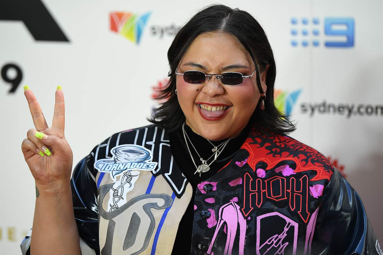 Kira Puru holds at the peace sign and pokes her tongue out at the 2019 ARIAs