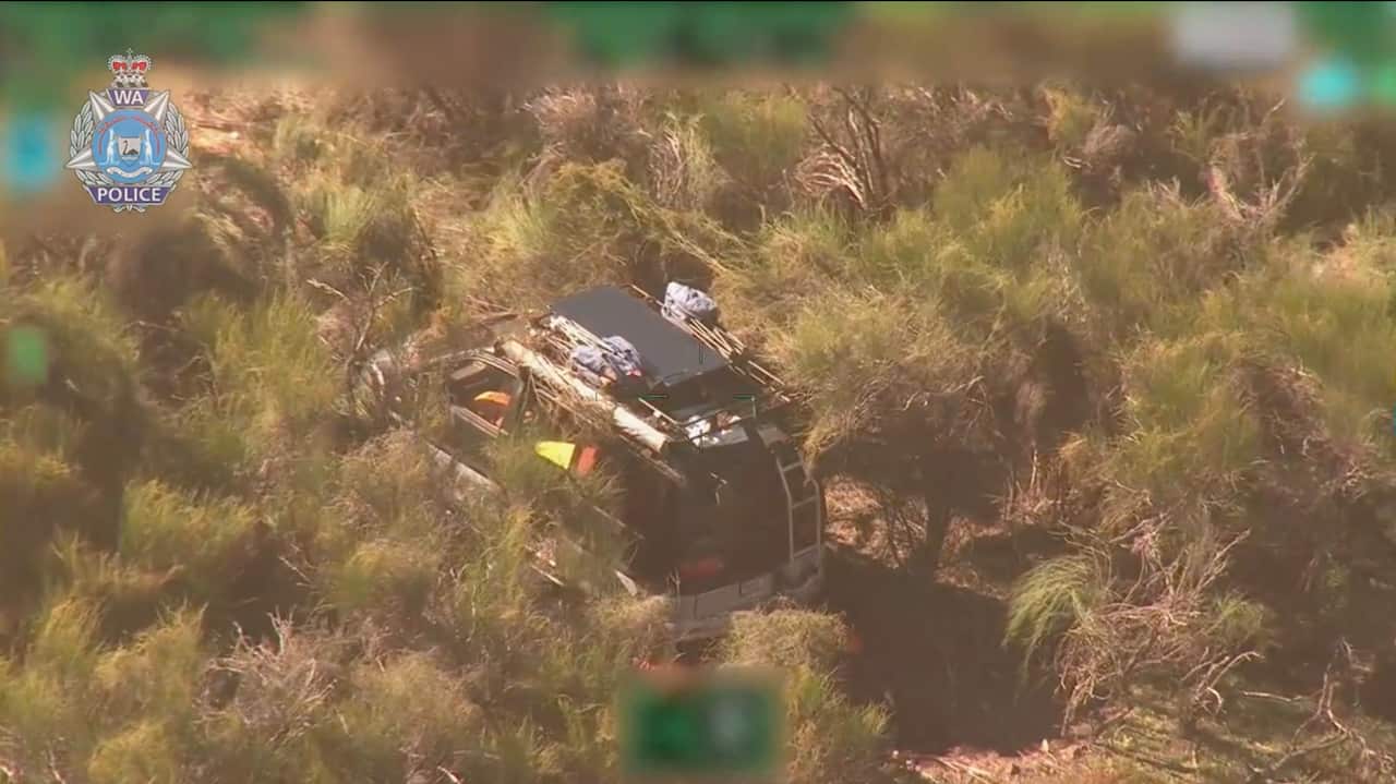 An aerial view of a van sitting amid dry bushland scrub.
