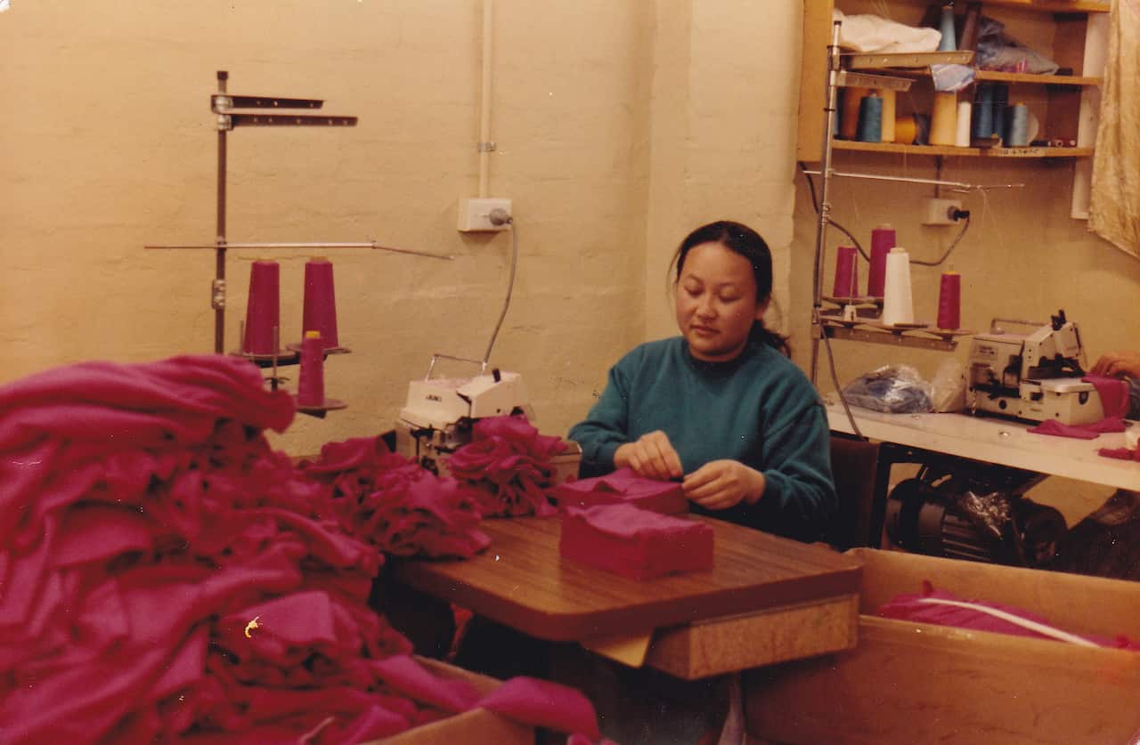 Chong Vang working at sewing factory (Sarah Thao).jpg