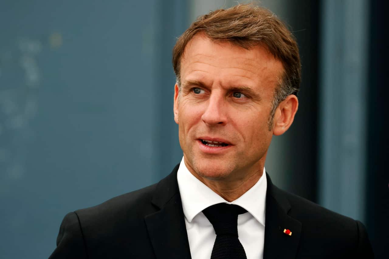 Emmanuel Macron wearing a black suit.