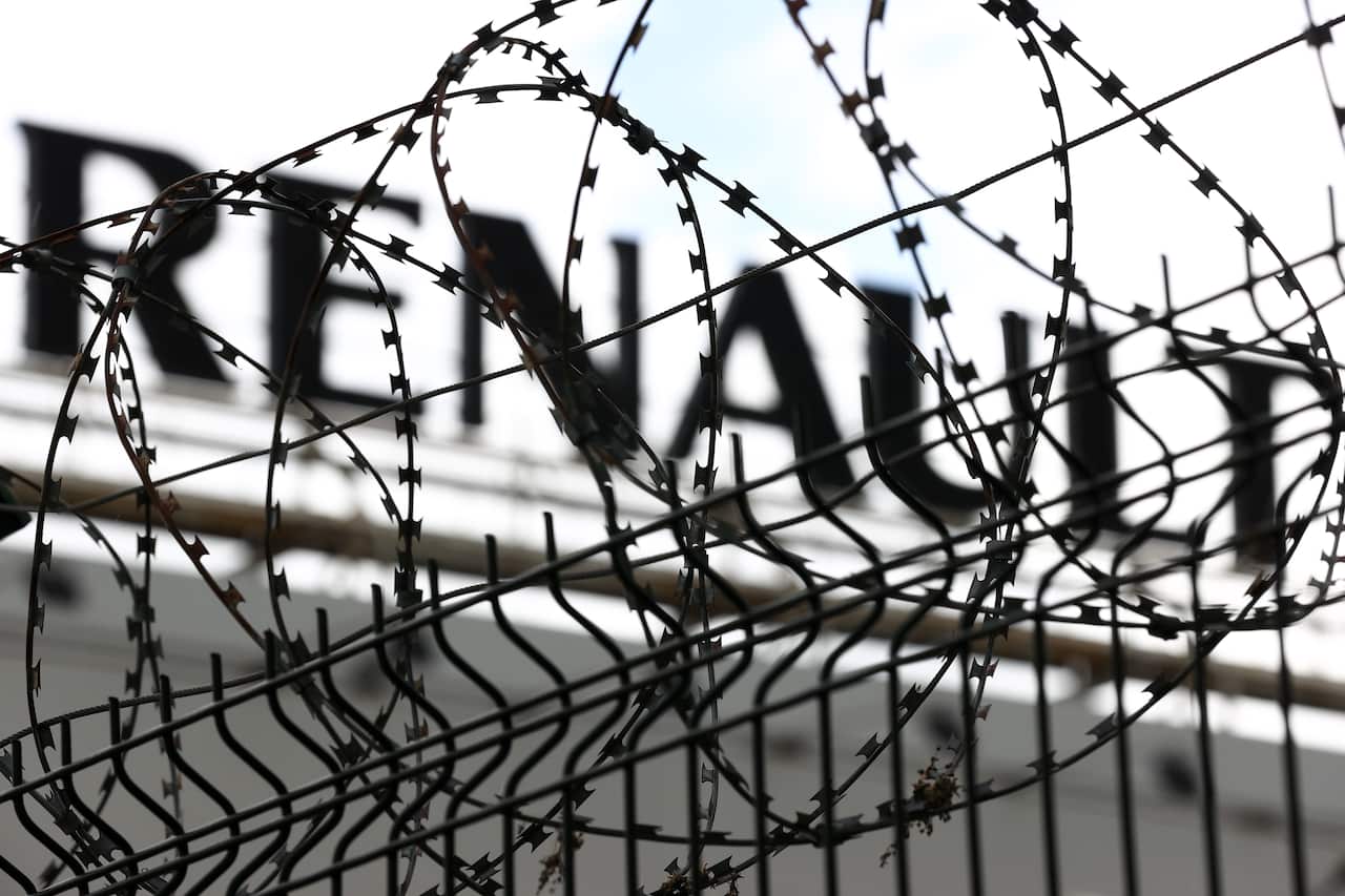A Renault sign behind barbed wire