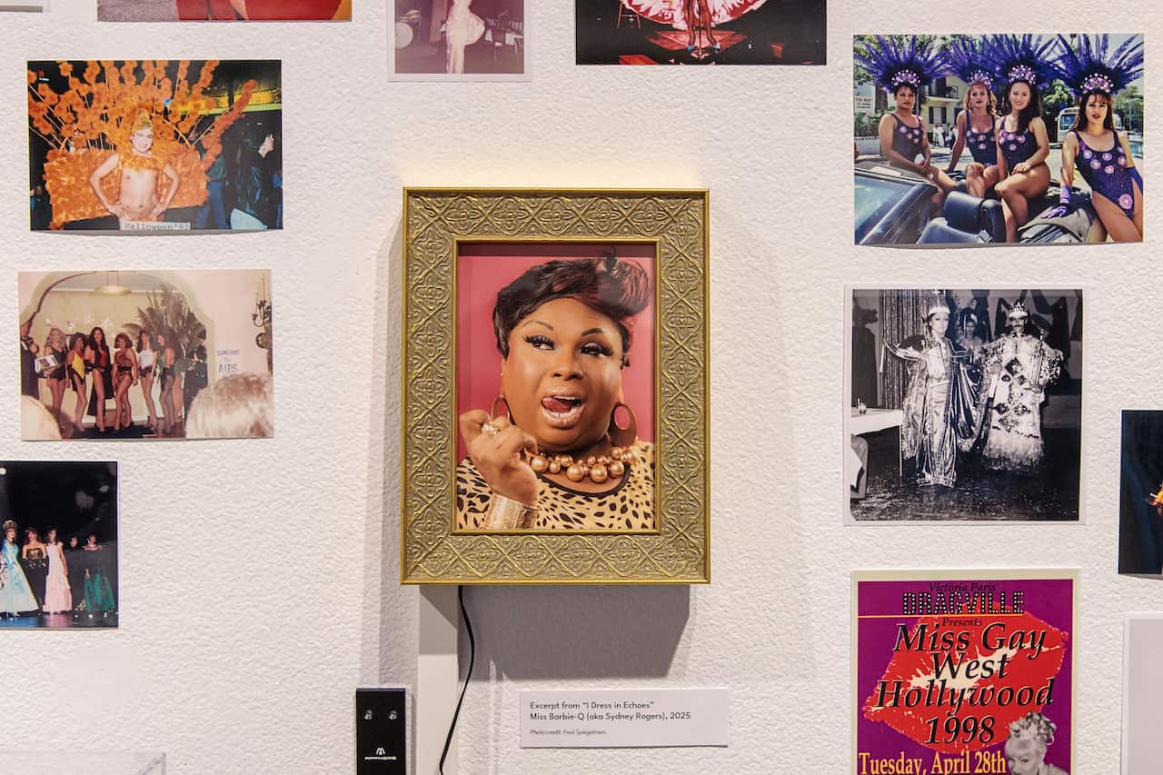 A wall with pictures of drag queens.