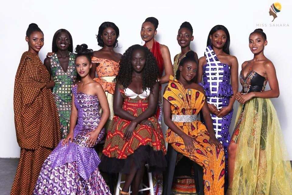 A group of black women in dresses with different patterns.
