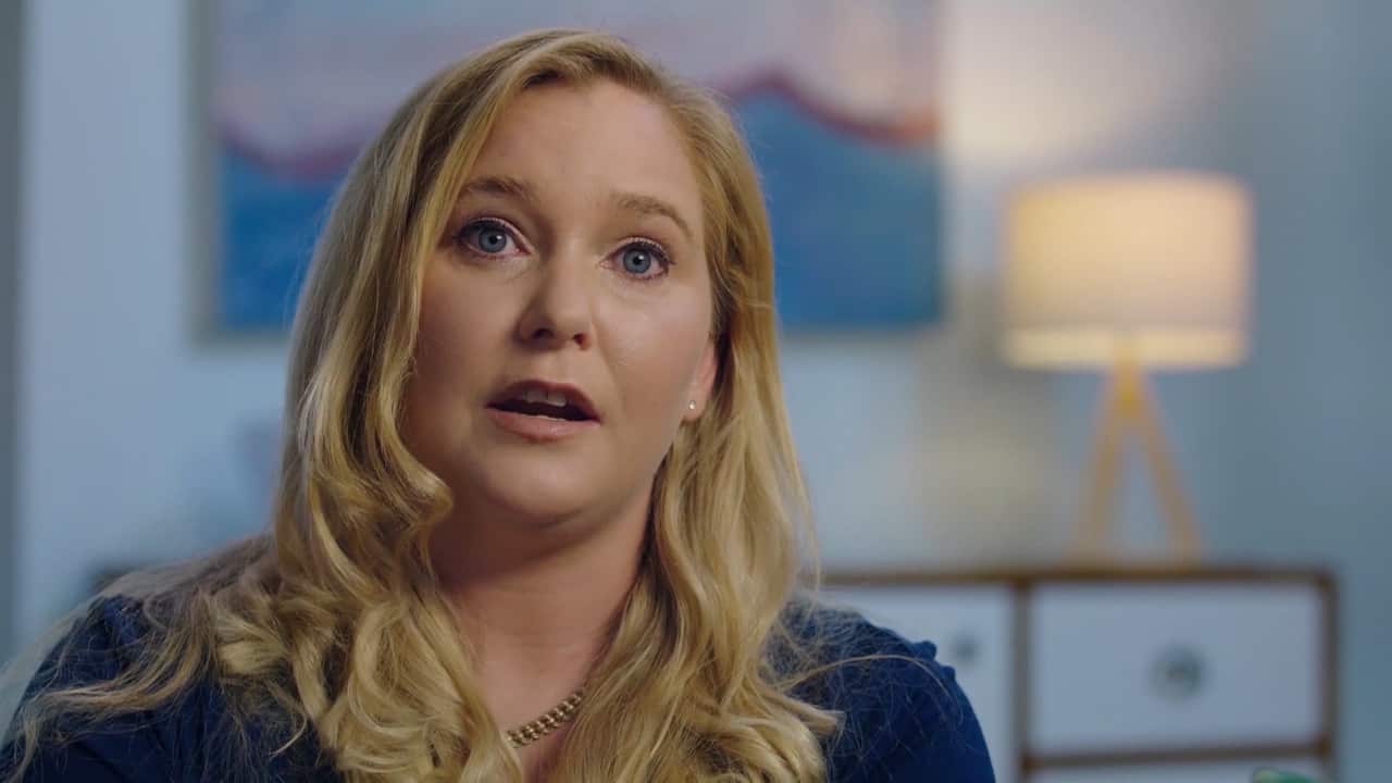 A woman with blonde hair in a living room.
