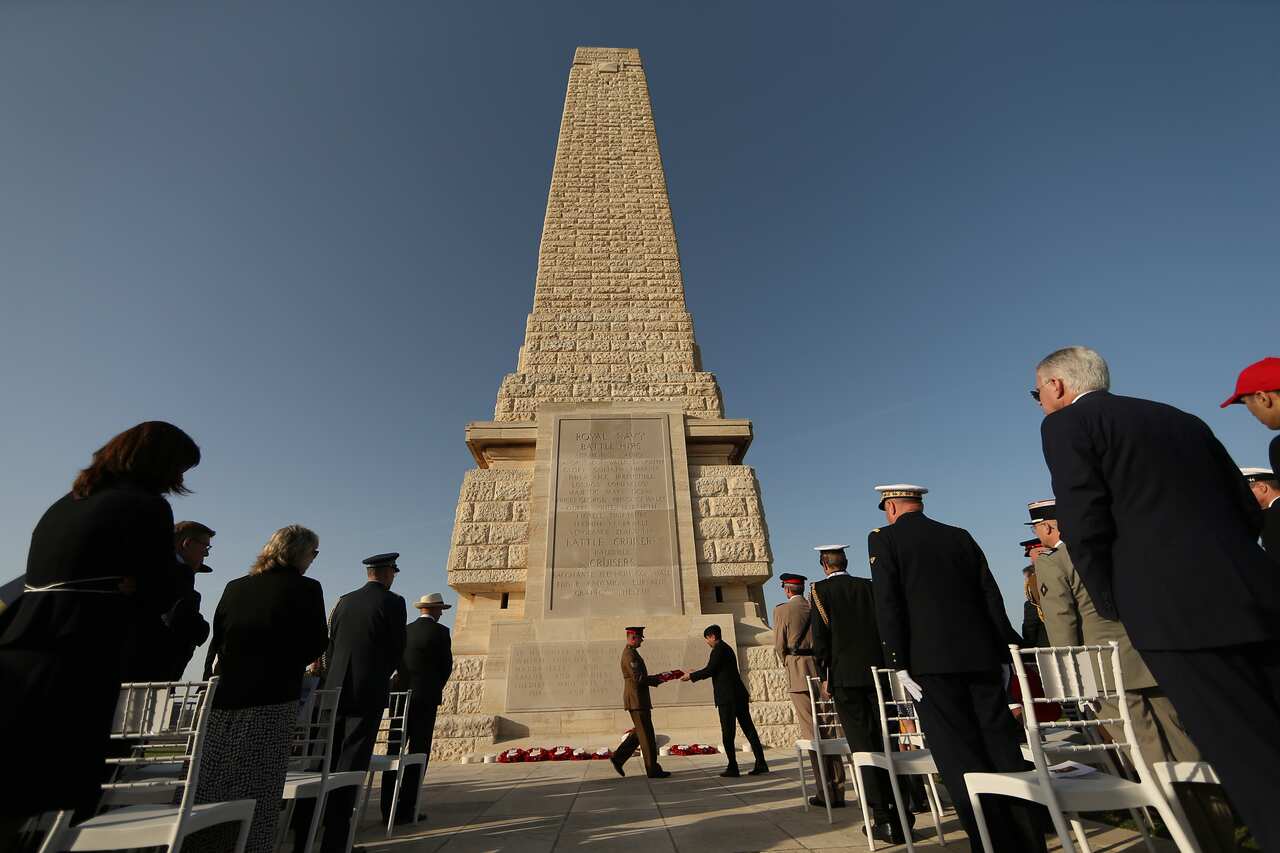 Soldiers standing at a memorial.