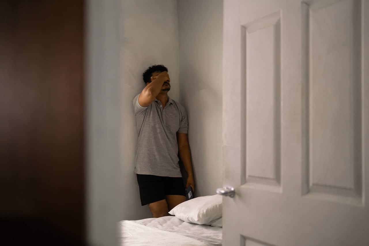 Frustrated man covering his face in disappointment. addictions and mental health concept