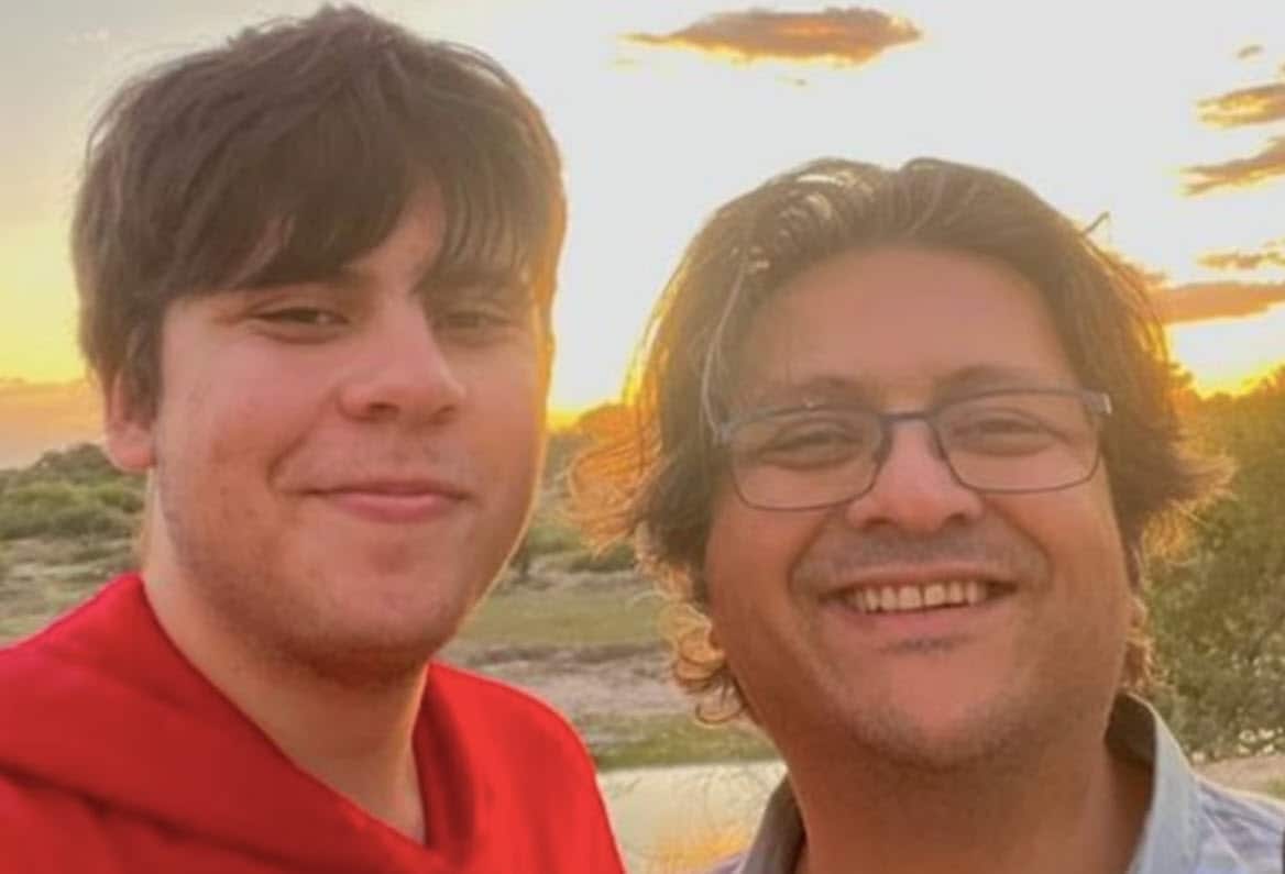 Two people smile at the camera.