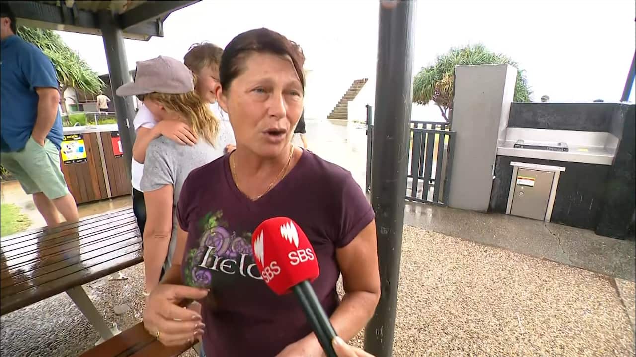 A woman speaking to a journalist.