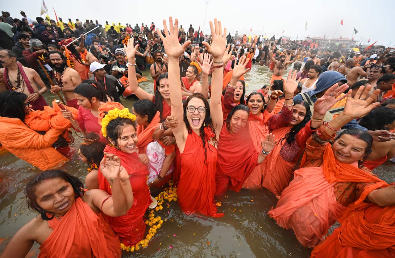 Women ascetics take a holy dip at the Maha Kumbh Mela on the occasion of Makar Sankranti on 14 January at Prayagraj.