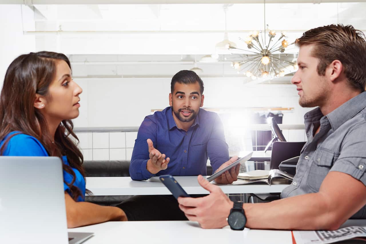 Small group of people having business meeting, male and female colleagues having disagreement