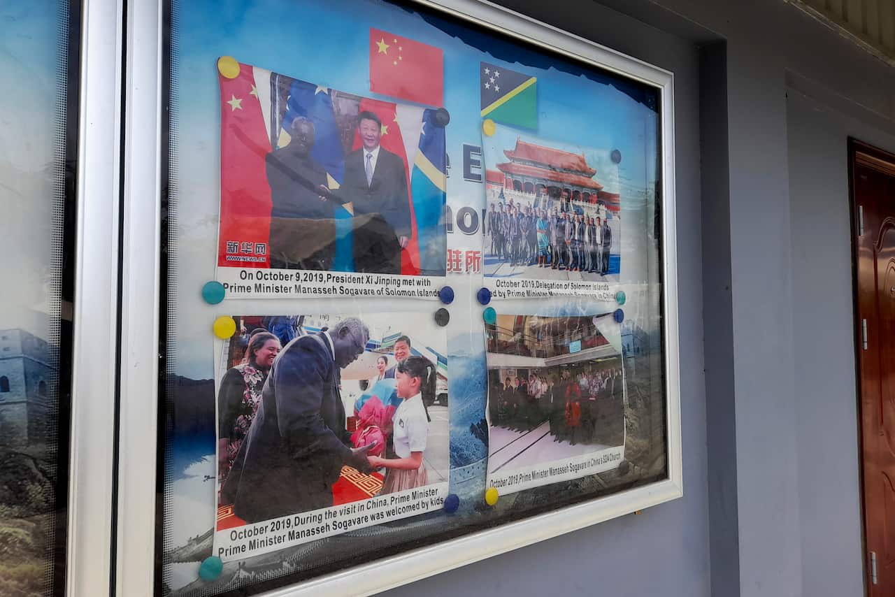 A display case shows photos outside Chinese Embassy in Honiara, Solomon Islands, Saturday, April 2, 2022. 