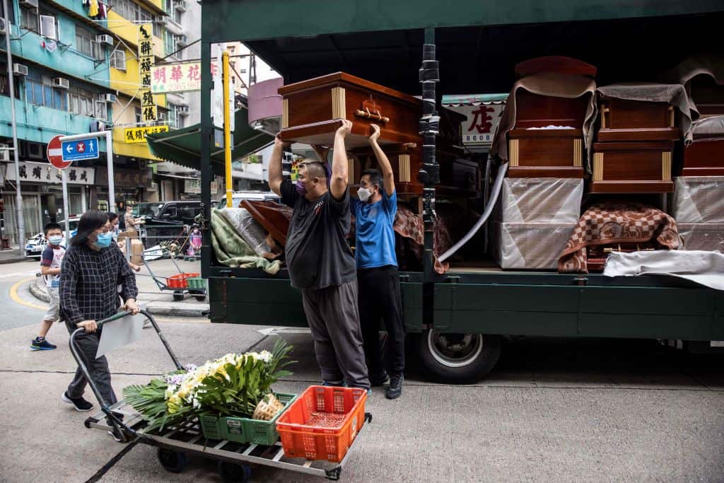 Empty coffins are delivered to a funeral services shop and funeral parlours in the Kowloon district of Hong Kong.