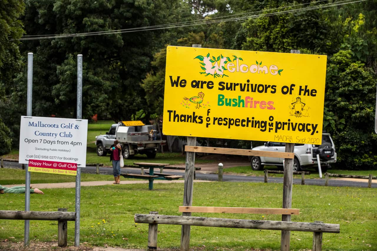 A hand drawn sign reading "we are survivors of the bushfires, thanks for respecting our privacy."