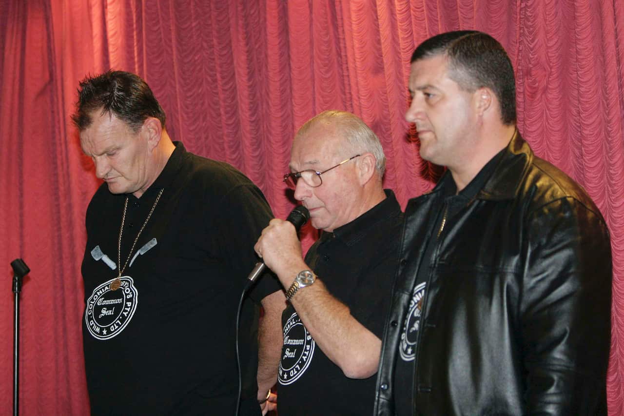Three men wearing black clothes