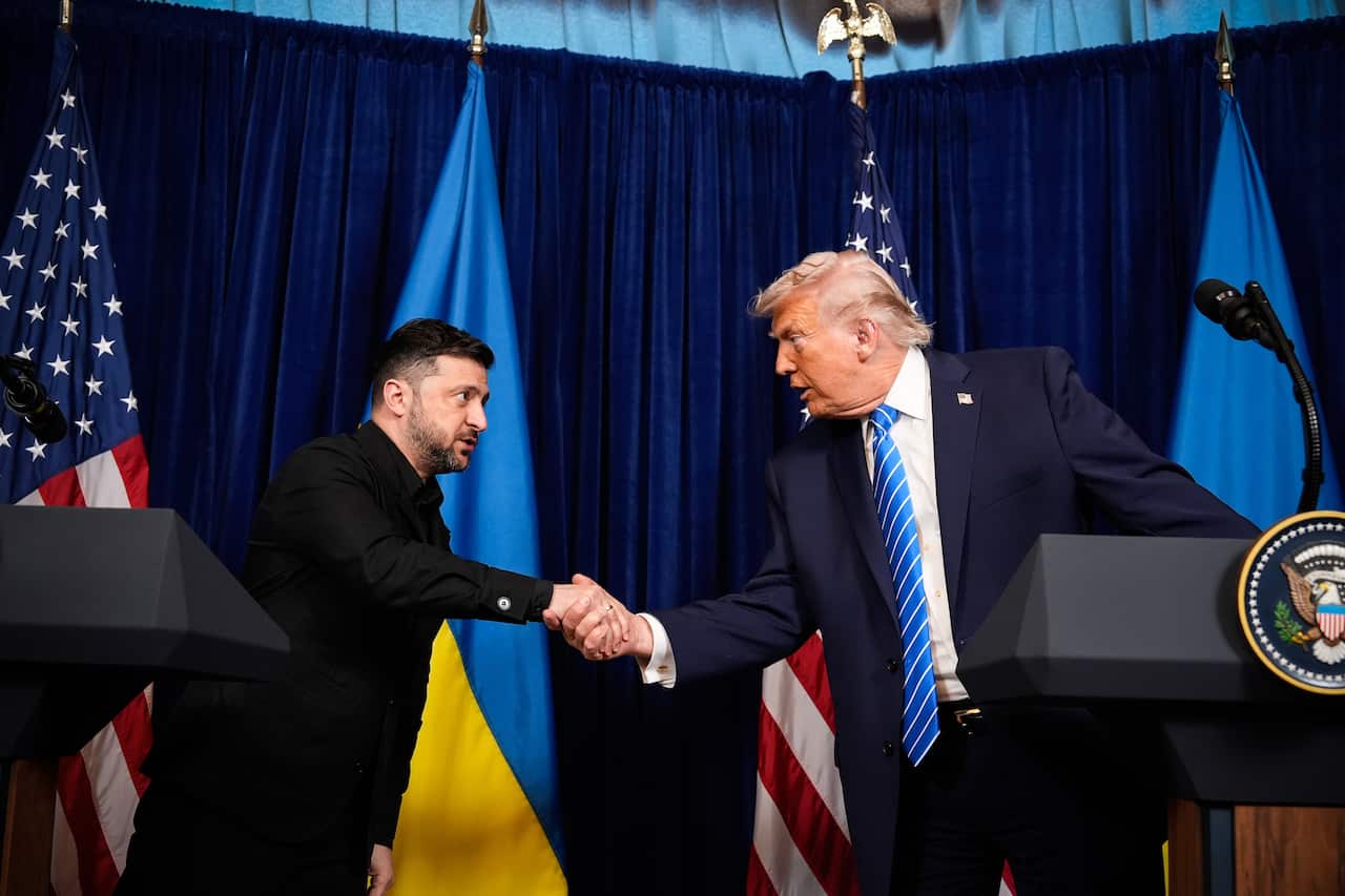 Donald Trump and Volodymyr Zelenskyy shaking hands.