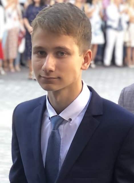 Boy facing camera in suit.