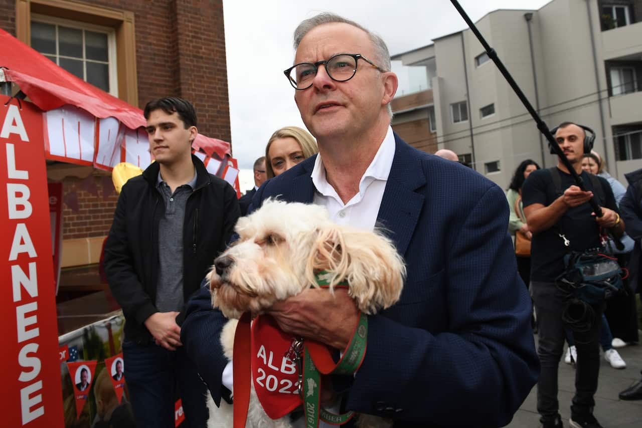 A man holding a dog.