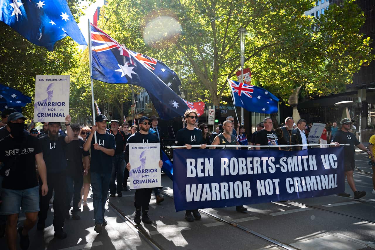 A rally in the street, with many Australian flags, and a big banner in support of Ben Roberts-Smith.