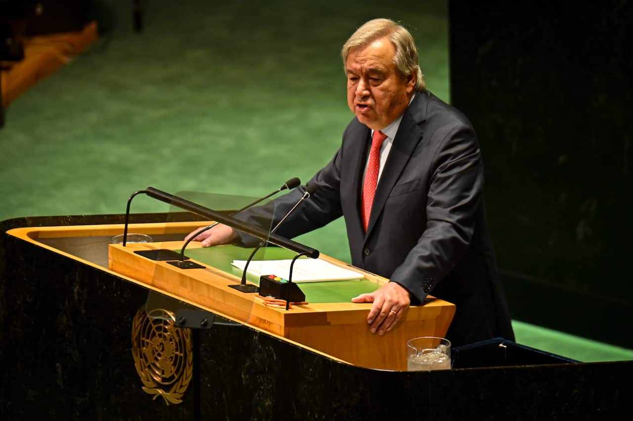 Antonio Guterres giving a speech at a podium.