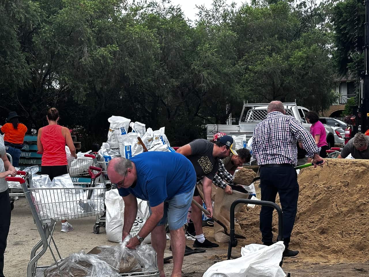 People preparing sandbags.