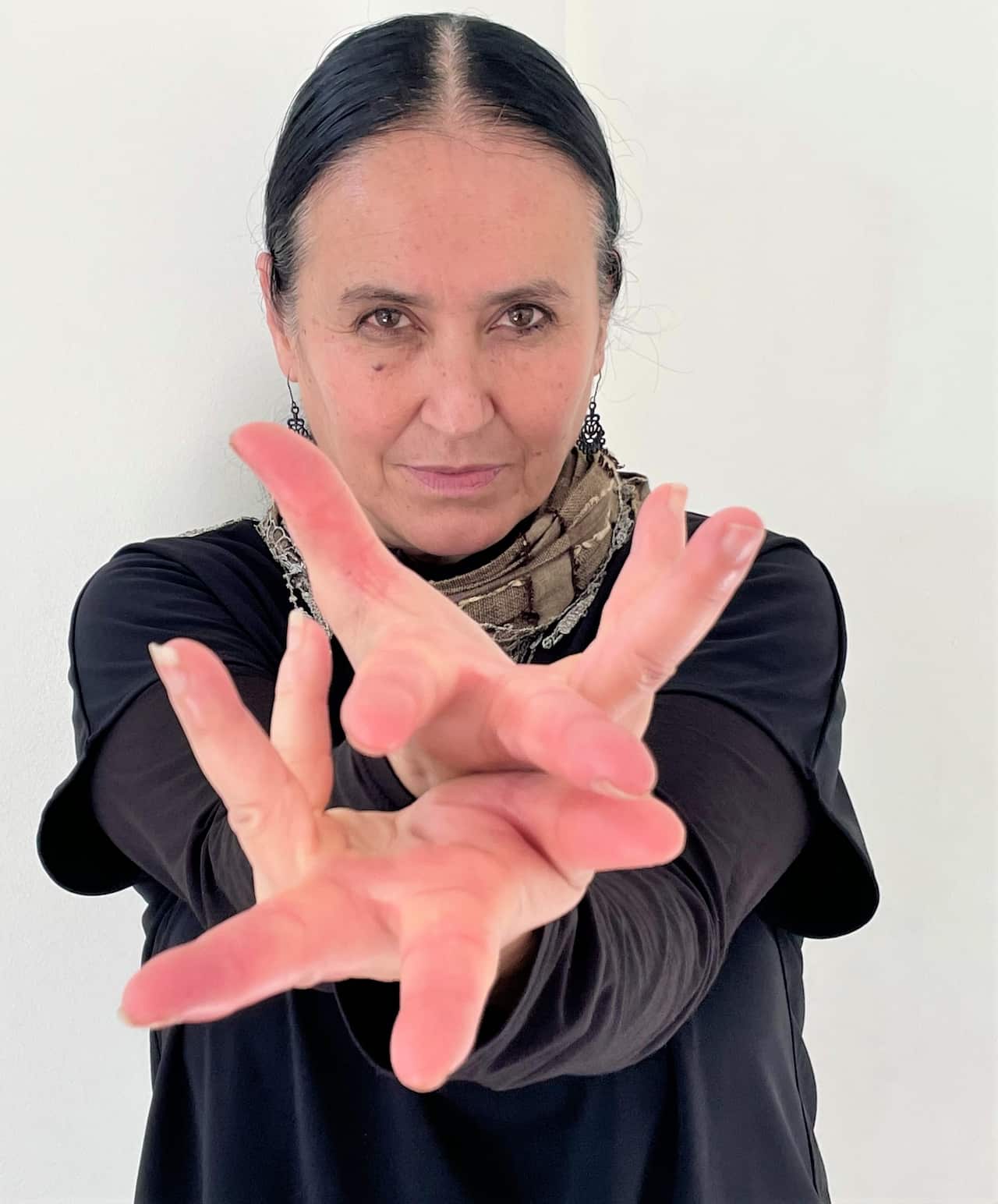 A woman holding her hands up to the camera