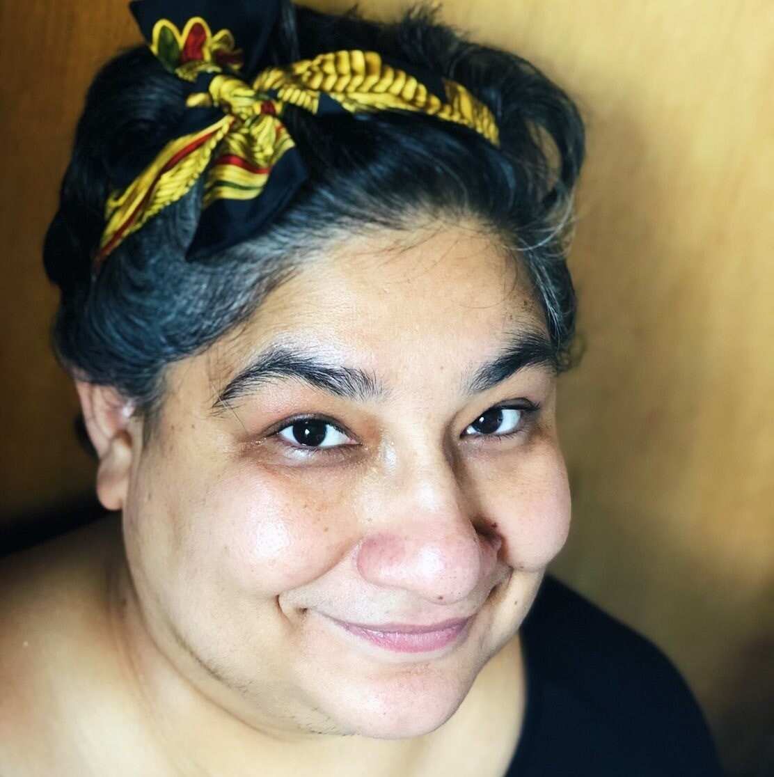 Gagandeep looking up and smiling at the camera. 