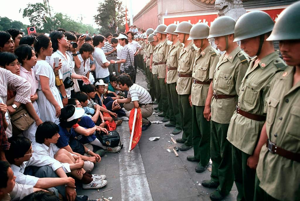 Protesters face a line of soldiers.