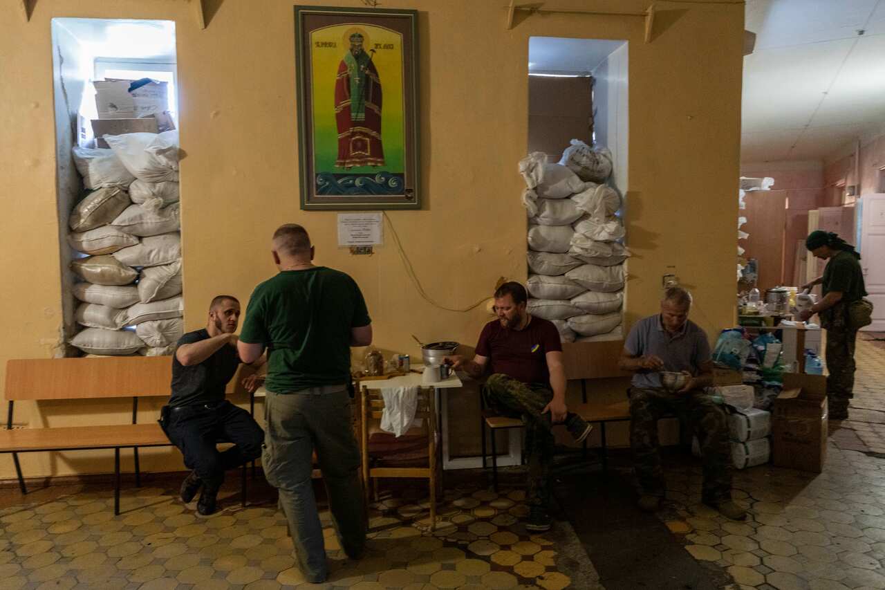 Members of a medical rescue team gather inside their temporary base 