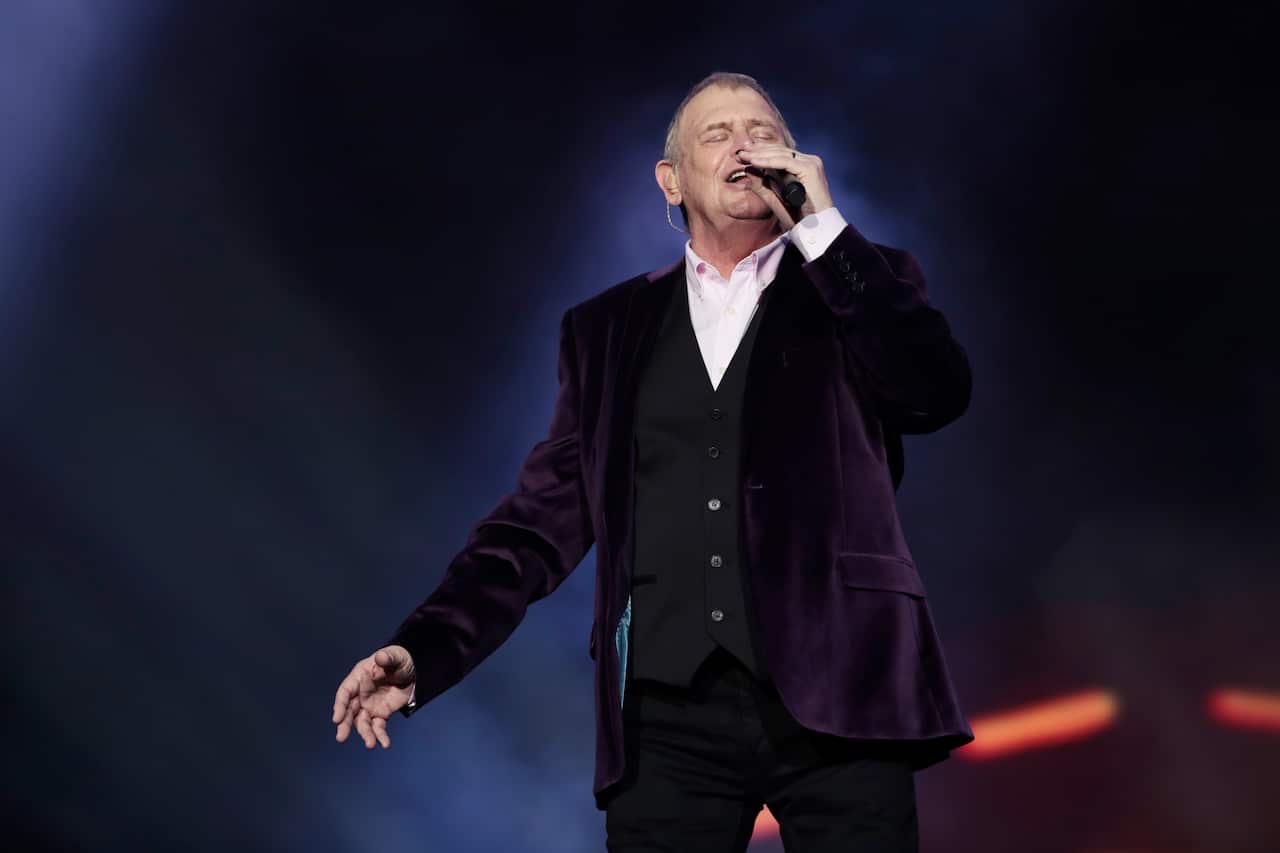 John Farnham singing on stage