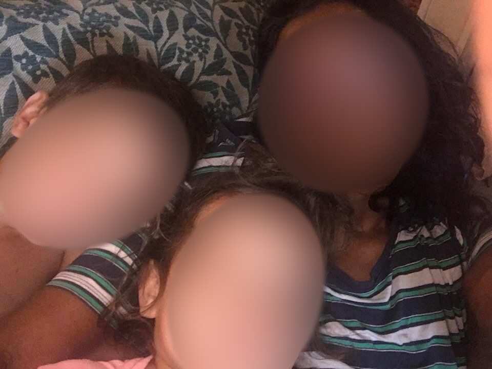 An image of a grandmother and two of her grandkids. Their faces are blurred for privacy reasons.