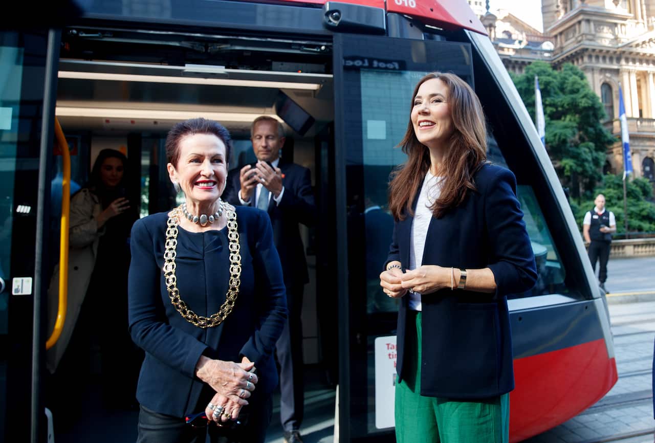 Crown Princess Mary of Denmark with City of Sydney Lord Mayor Clover Moore standing outside a light rail carriage.