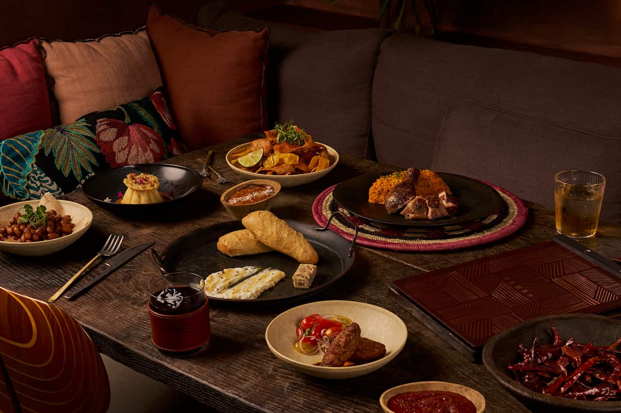 Clockwise from left_ Charred Peanuts, Cassava Flan, Cassava Chips, Jollof Rice, Tapalapa, Akara.jpg