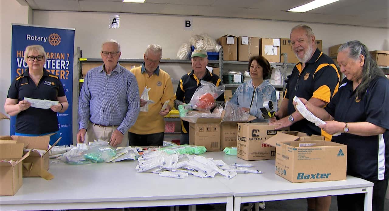 Rotary Australia volunteers poacking medical supplies.