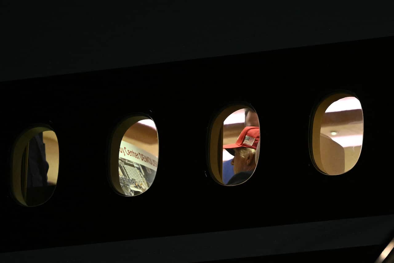 An external shot of Air Force One with Donald Trump's head seen through one window and a render with the title "Kennedy Center Demolished" through the other.