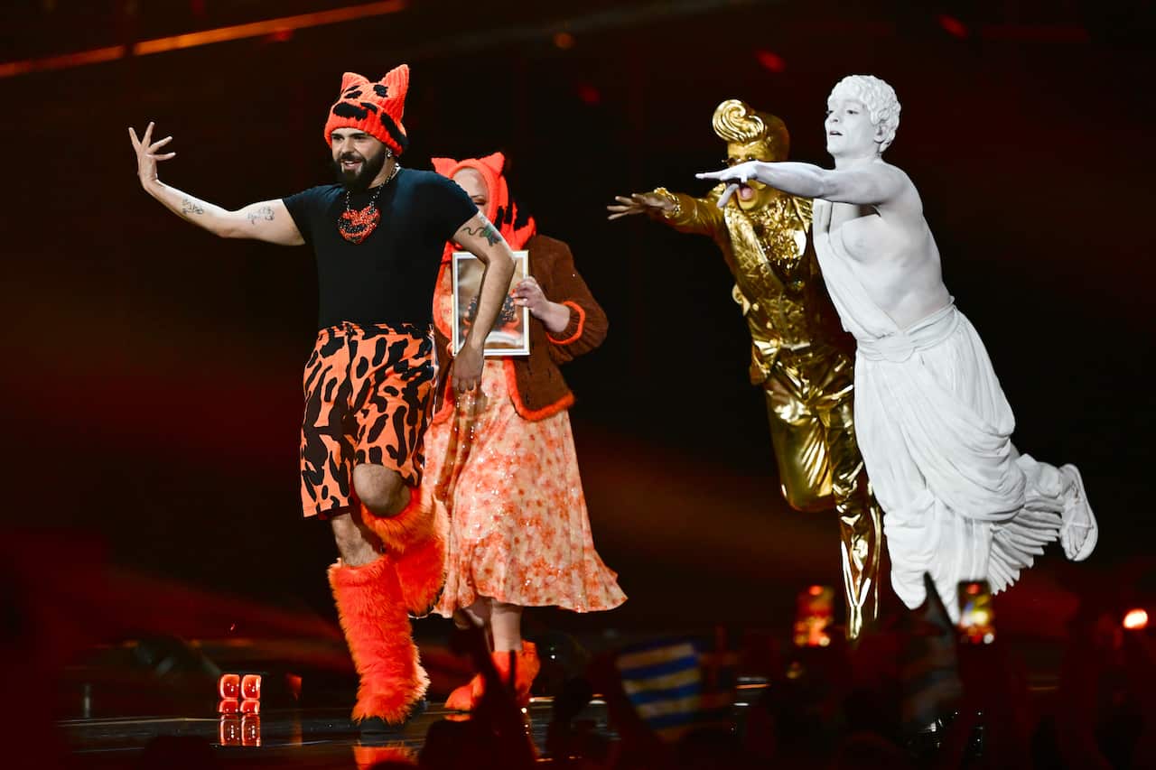 Performers sing at a stage