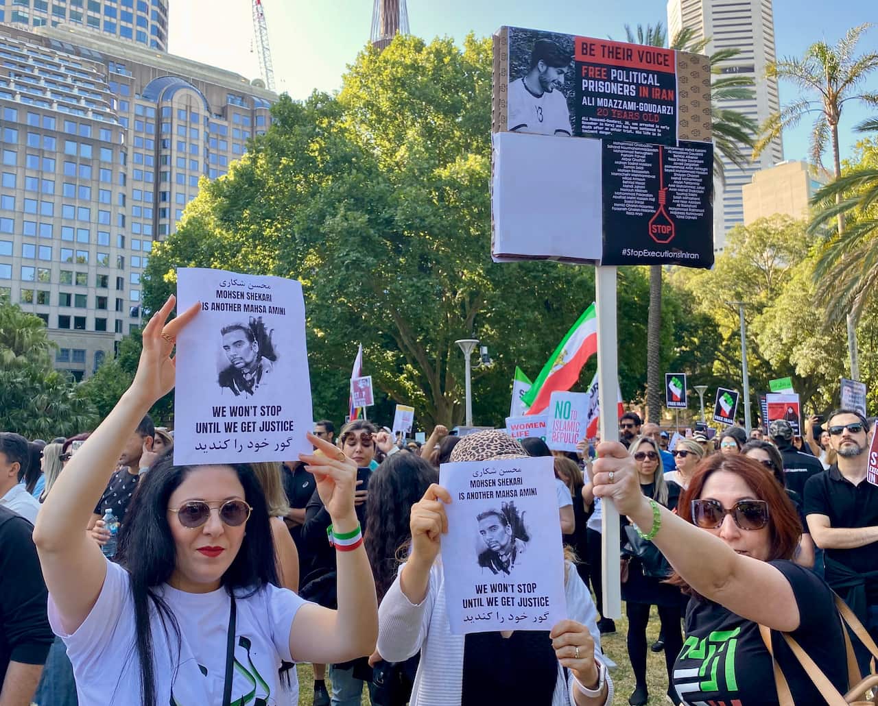 protesters holding Mohsen Shekari's photo in their hand, a young man who was executed this week in Iran