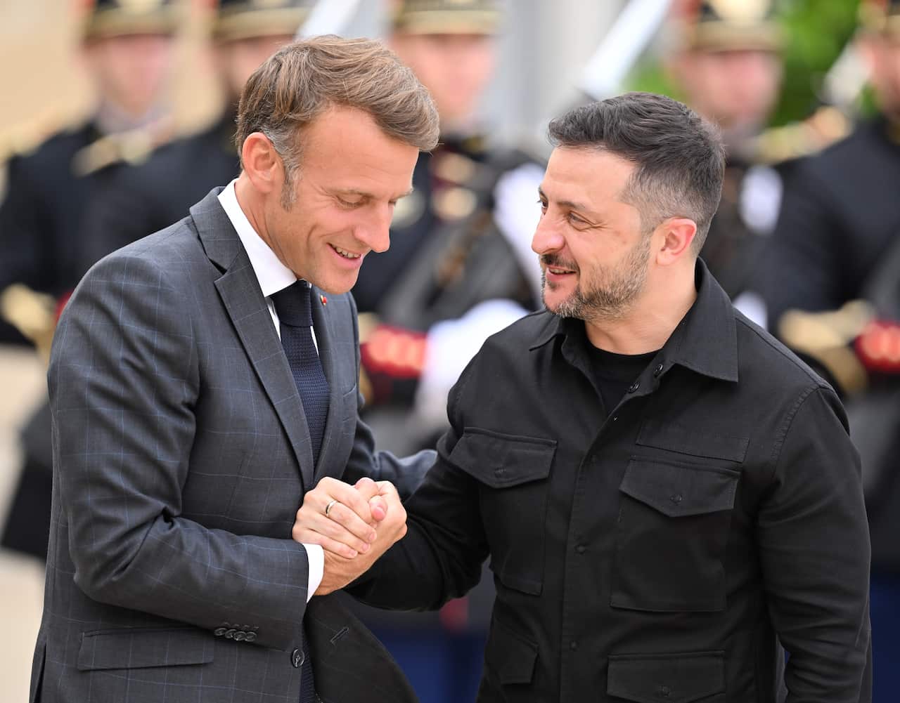 Volodymyr Zelenskyy at the Elysee Presidential Palace in Paris shaking hands