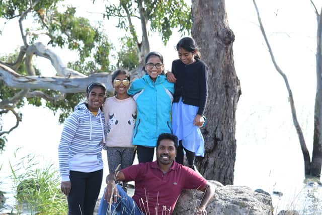 Neil Para with his wife Sugaa and their daughters at a park. 