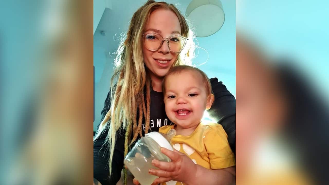 Sophie Harmann holds her young daughter who are both smiling. 