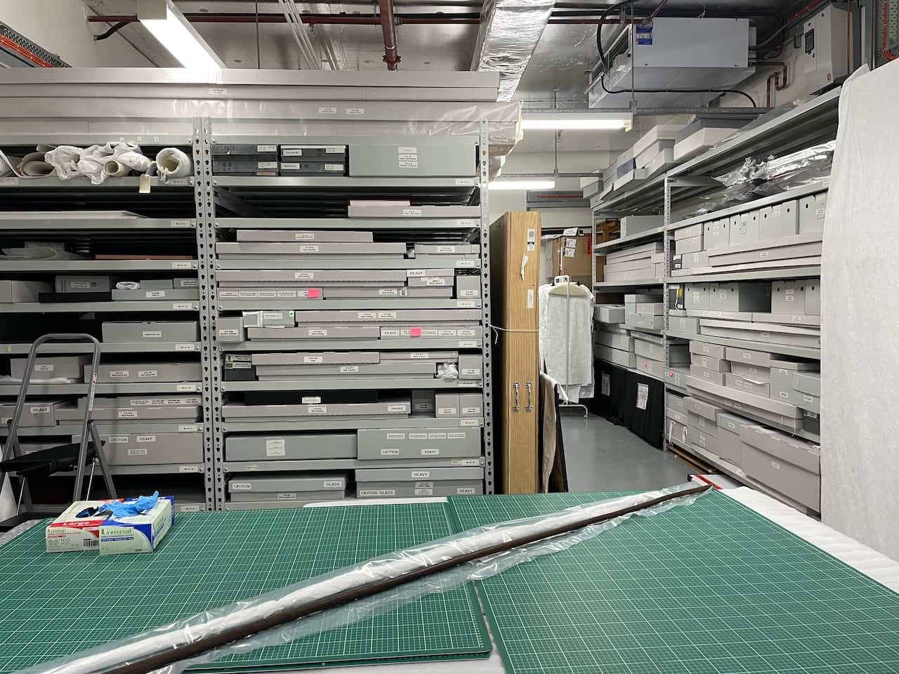 The Art and Objects vault beneath AIATSIS where artefacts such as bark paintings, didgeridoos, spears are kept on shelves in museum-grade boxes.