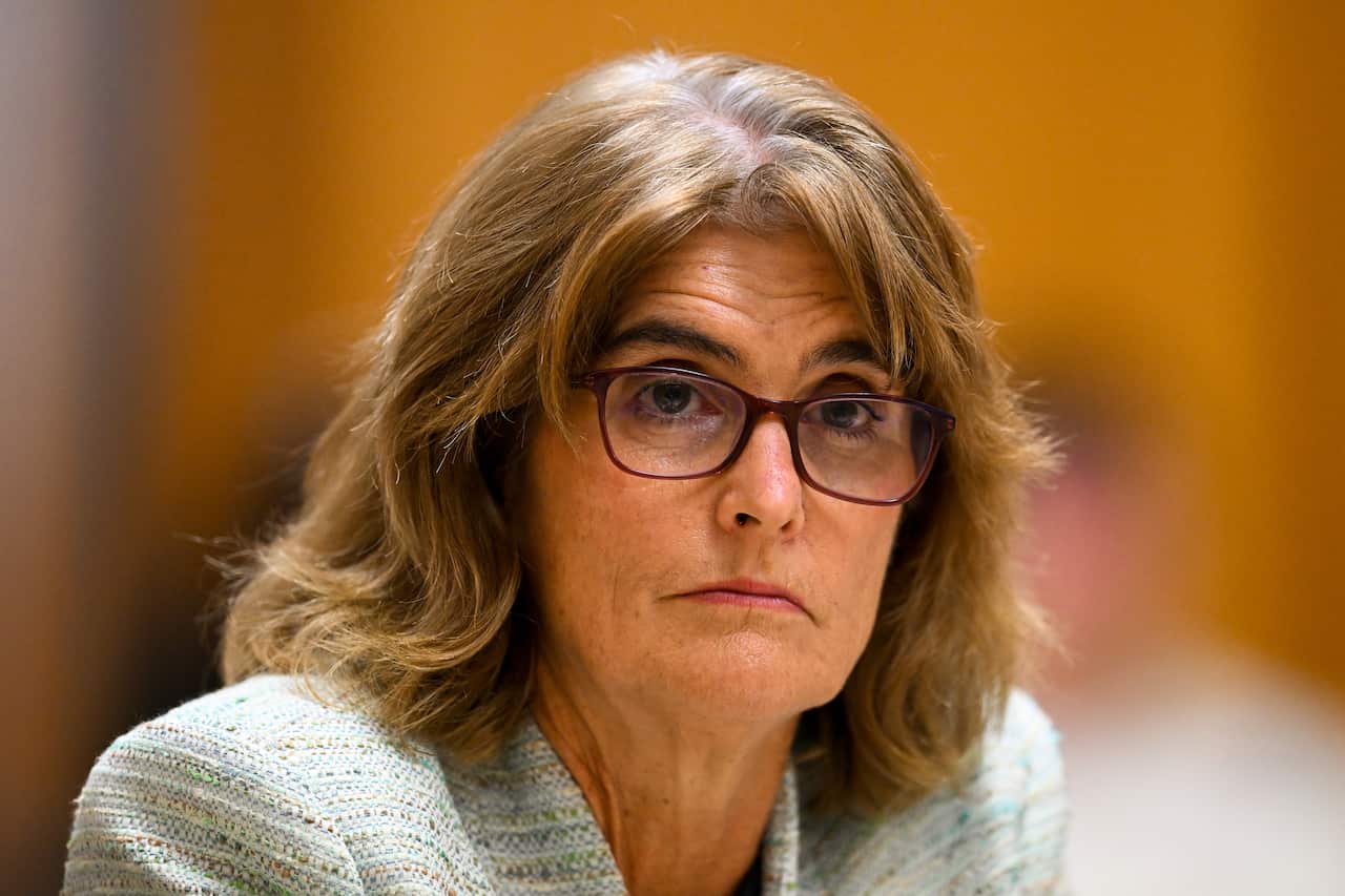 A woman wearing glasses is looking.