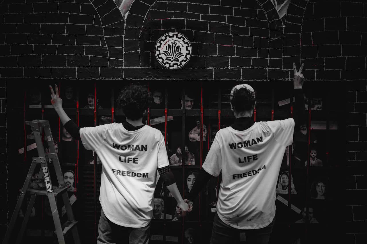 Bahar and Samaneh in front of their artwork in Melbourne