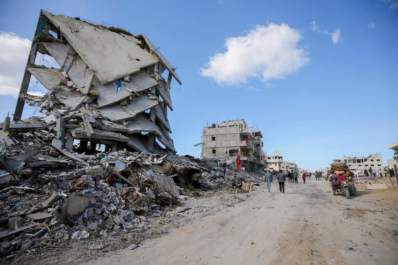 Destroyed buildings next to a dusty roadway